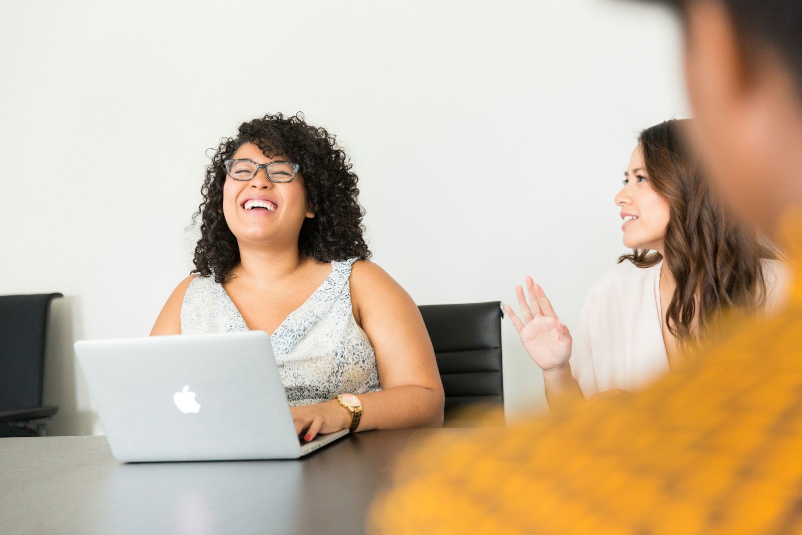 Aspis team members collaborating around a laptop during a work meeting